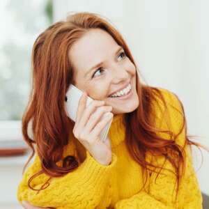 red hair woman on phone smiling